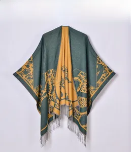 Detailed knit texture of vintage jacquard shawl with green floral pattern and gray fringe