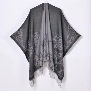 Detailed view of the gray pastoral shawl featuring intricate jacquard patterns and tassels