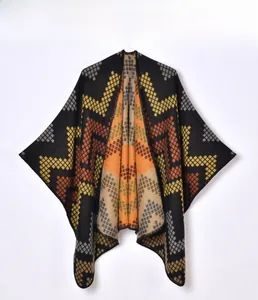 Close-up of geometric diamond pattern and thick knit texture on women's winter poncho