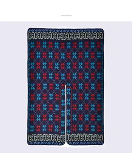 Detailed view of dark blue knit shawl with red star pattern and wavy edge accents