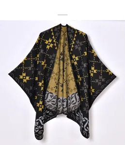 Close-up of thick knit shawl with geometric star patterns and detailed hem stitching