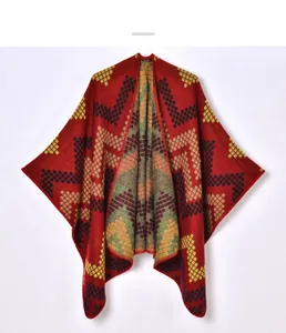 Detailed close-up of geometric diamond pattern on thick winter knit shawl cape
