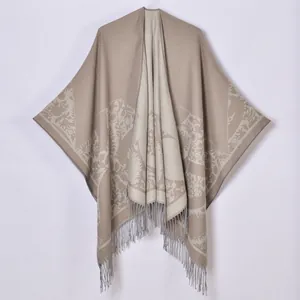 Detail of bohemian floral knit shawl with elegant fringe and geometric patterns