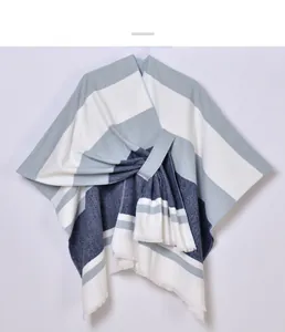 Detail of knit shawl with horizontal stripes, fringe hem and tied waist belt