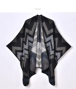 Detail of knitted geometric diamond pattern on thick winter shawl poncho for women