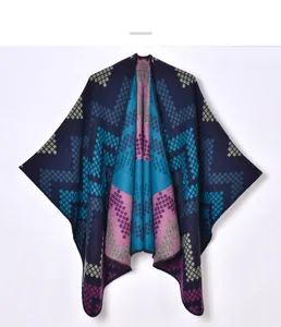 Detailed view of the jacquard geometric knit pattern on the blue winter poncho cape