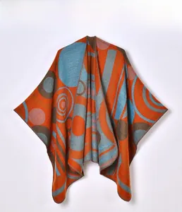 Detail of soft knit shawl with vibrant geometric color blocks and fine edge stitching