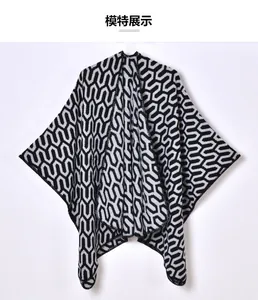 Close-up of black and white hexagonal geometric pattern on soft knit shawl wrap