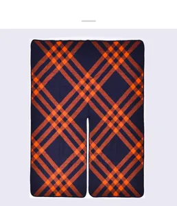 Detail of navy blue and orange plaid oversized warm shawl with central opening cut