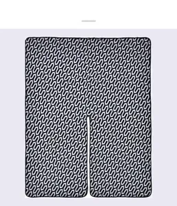 Close-up of black and white geometric jacquard knit pattern on a winter shawl cape