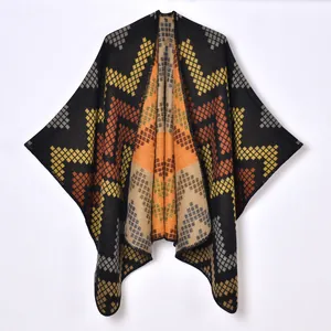 Women's thick knit poncho with geometric diamond pattern in black and orange colors