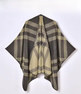 Close-up of thick oversized charcoal and beige plaid shawl with fine knit texture detail
