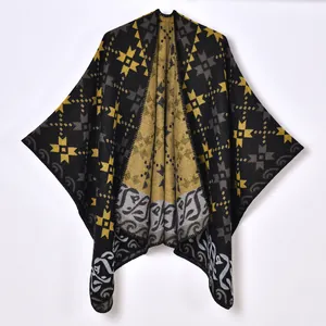 Thick knit bohemian poncho with yellow geometric patterns on black fabric