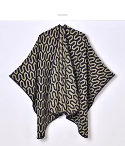 Detailed knit texture of navy and beige geometric chain pattern on an open-front shawl