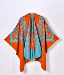 Close-up of knit fabric showing orange and blue paisley pattern with stitched edge