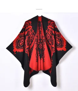 Detail of vintage red and black floral jacquard pattern on a warm winter poncho cape