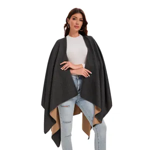 Detail of double-sided cashmere-like shawl showing dark grey and camel color split design