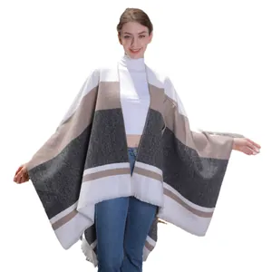 Elegant striped poncho with fringe tassels in white, camel, and dark grey tones