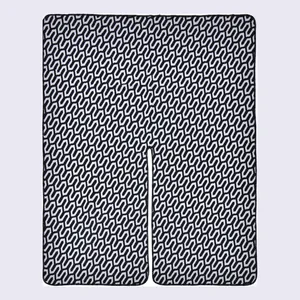 Women's knit poncho wrap with black and white geometric zigzag patterns and center slit