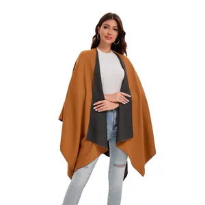 Detailed view of caramel and grey double-sided cashmere cape with premium stitching