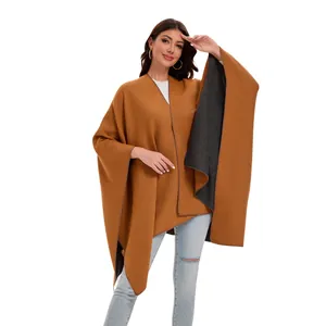 Detail view of double-sided knit poncho with split front design and caramel grey tones