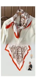 Close-up of silk-feel scarf with vintage ethnic patterns and bright orange borders