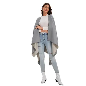 Detail view of double-sided grey knit shawl with stylish front split and soft texture