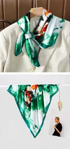 Detail showing high-quality faux silk scarf with green floral pattern on beige suit