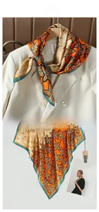 Detail of silk-like satin scarf with orange leaf pattern and contrast green edging