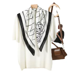 Elegant white short sleeve knit top with a camellia print silk scarf in classic black and white