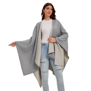 Detail of the high-quality stitching and dual-sided knit fabric on gray-beige poncho