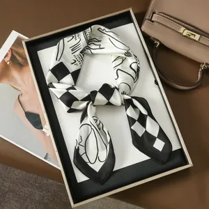 Classic black and white checkered silk scarf with artistic lines on a luxury tray