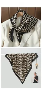 Macro view of square silk scarf with Greek key pattern styled on a white blazer