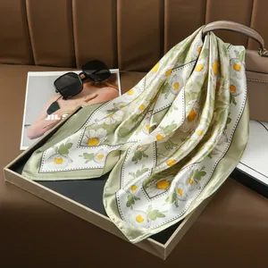 Sage green daisy floral square silk scarf styled as a fashion accessory on handbag
