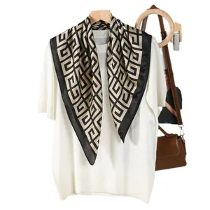 Elegant 70cm silk square scarf with Greek fret pattern on a chic knit top