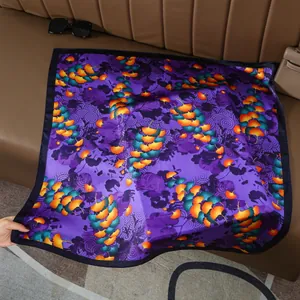 Detailed view of 70cm purple square silk scarf with ginkgo leaf pattern on leather