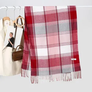 Classic red grey plaid scarf made of soft cashmere-like fabric hanging on a rack