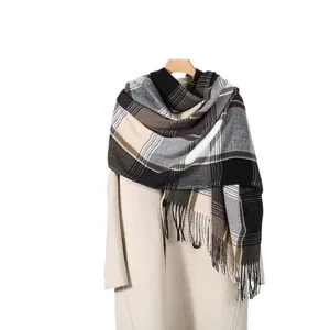 Classic plaid scarf in black and beige tones with fringes on a wool coat