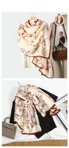 Detail of floral printed linen-cotton scarf with fine brown hem and soft texture