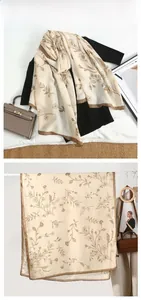 Detail view of light beige cotton linen scarf featuring vintage floral print and fine edges