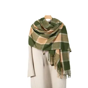 Classic green and beige plaid cashmere-feel scarf with tassels on a wooden hanger