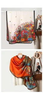 Detail showing floral print shawls in cream and orange with smooth silky texture