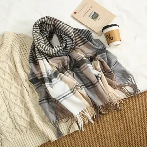 Detail of soft striped cashmere scarf texture with classic tassels in earthy tones