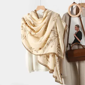 Elegant floral print cotton linen scarf for women in beige and brown hanging on a hanger