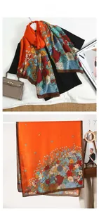 Detailed view of lightweight orange floral print scarf with vibrant retro patterns