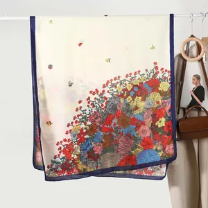 Detailed view of floral printed scarf with contrast blue edges and soft linen texture
