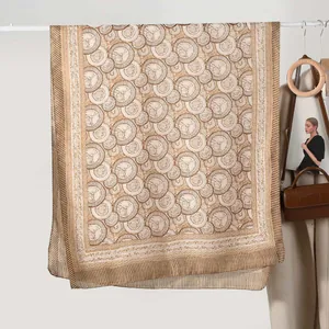 Elegant vintage pattern silk scarf in beige and brown hanging with stylish accessories