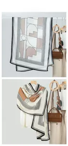 Detail showing geometric black, white and brown拼接 patterns on lightweight silk scarf