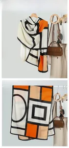 Detail of color-block geometric scarf with modern Mondrian art pattern displayed on hanger