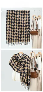 Detail of classic houndstooth scarf with black fringe and yellow plaid pattern